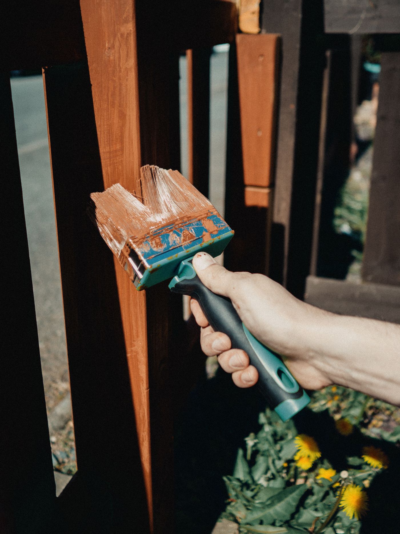 Brush applying a protective finish to exterior wood